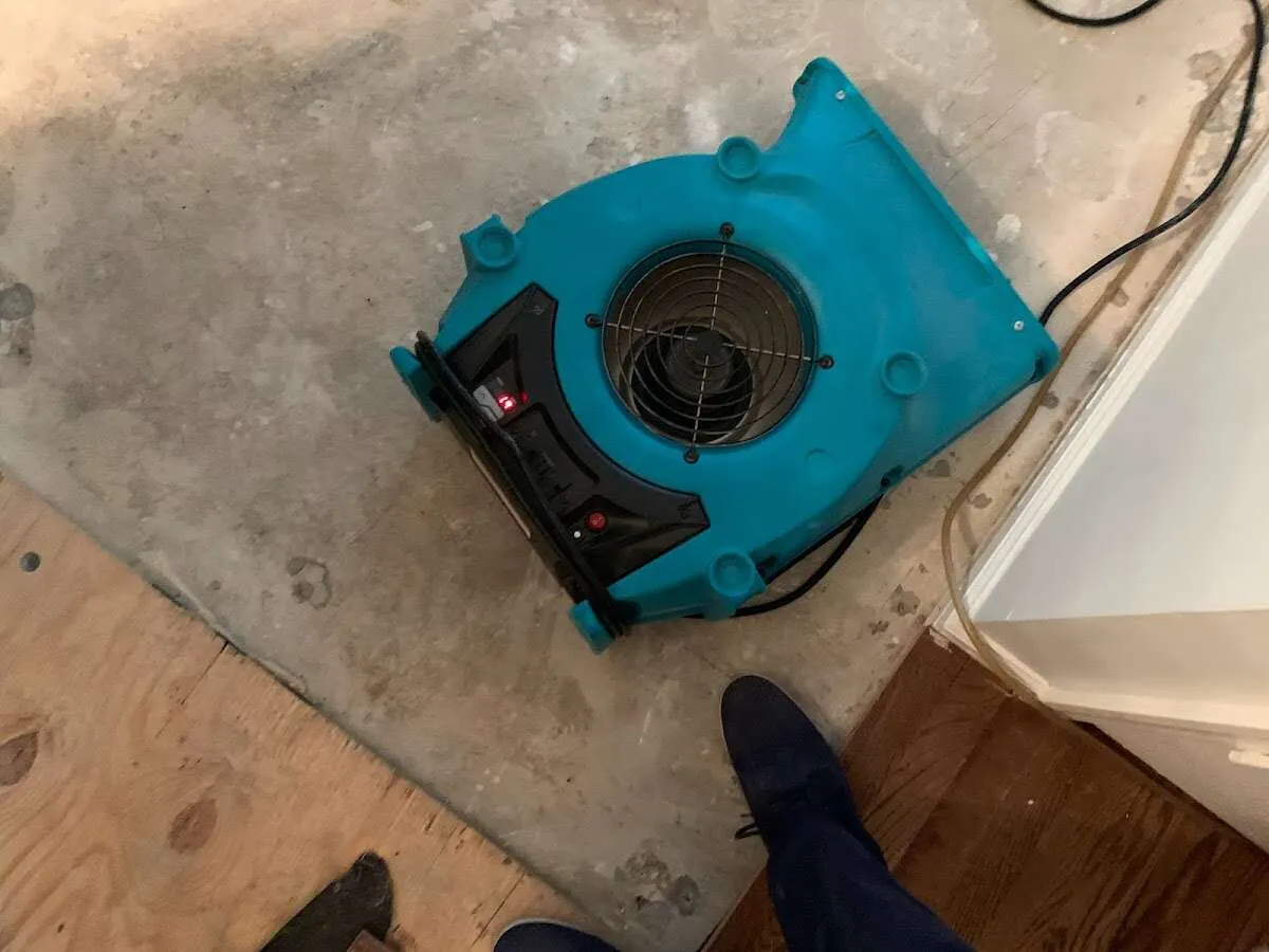 Air mover drying subfloor during Leak Detection & Repair in Petoskey